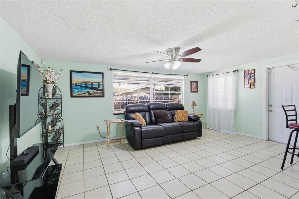 4904 Elmwood Street New Port Richey, FL 34653 - Photo 23 of 57 a living room with furniture and a window