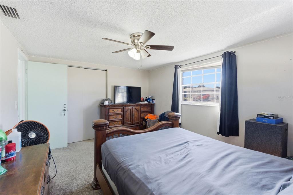 4904 Elmwood Street New Port Richey, FL 34653 - Photo 29 of 57 a bedroom with bed and window