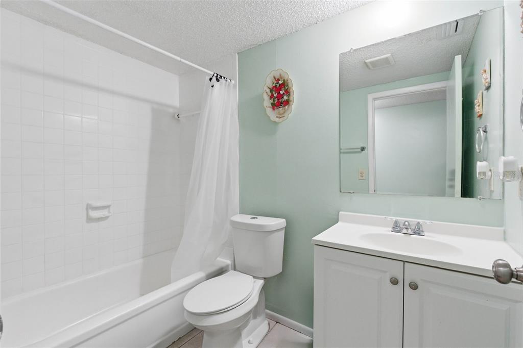 4904 Elmwood Street New Port Richey, FL 34653 - Photo 34 of 57 a bathroom with a toilet sink vanity and shower