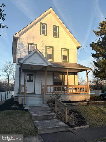 a front view of a house with a garden and plants
