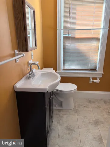 a bathroom with a sink vanity and a mirror