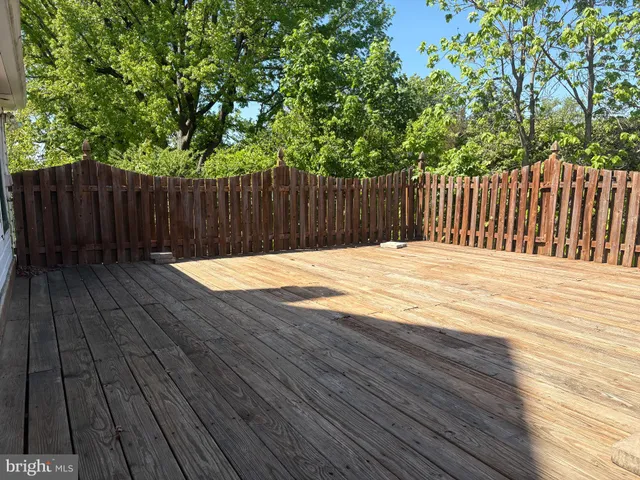 a view of backyard with a cabin and wooden fence