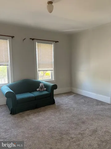 a living room with a couch and a window