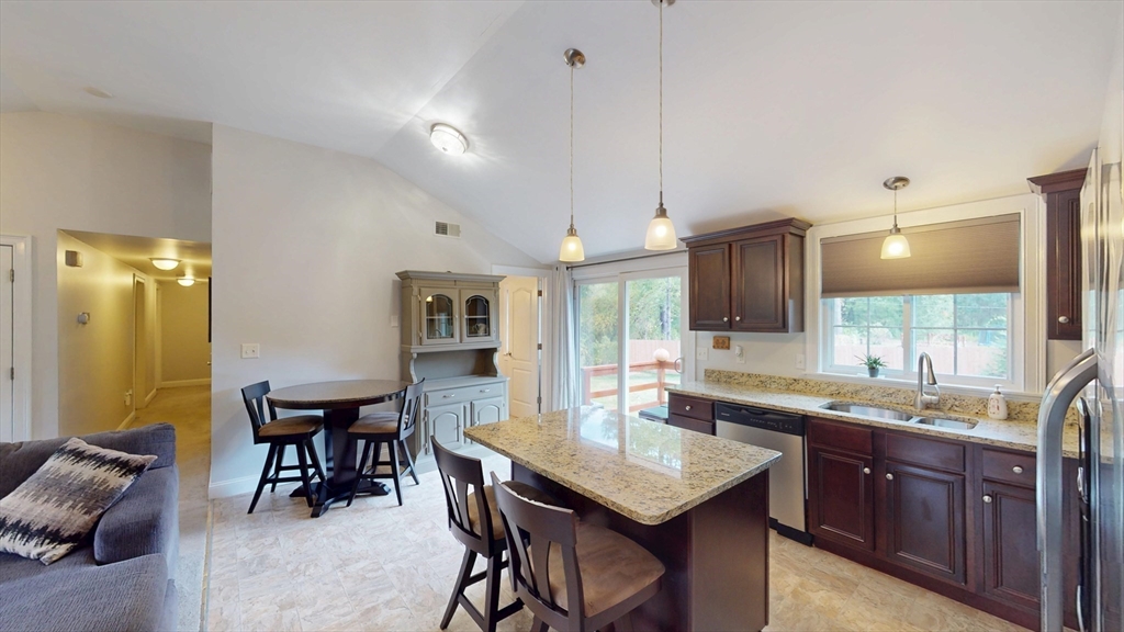 53 Walker Road Shirley, MA 01464 - Photo 9 of 29 a kitchen with granite countertop a sink dining table and chairs
