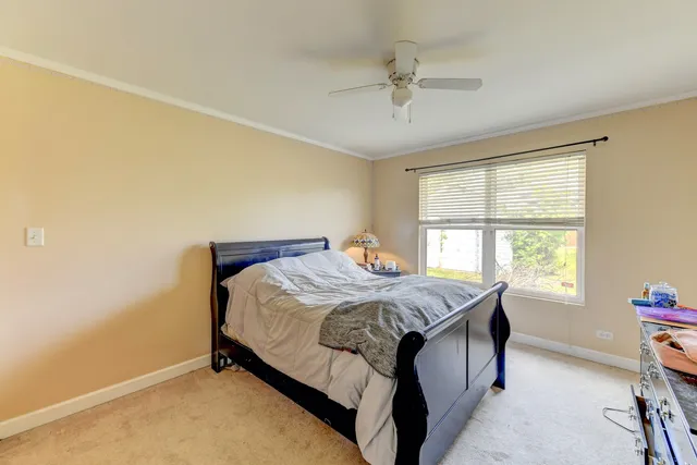 a bed sitting in a bedroom next to a window
