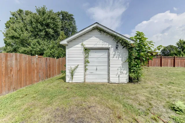 a view of a house with a yard and garage