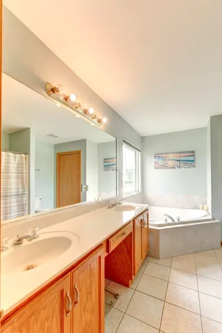 a large kitchen with a sink and a large window