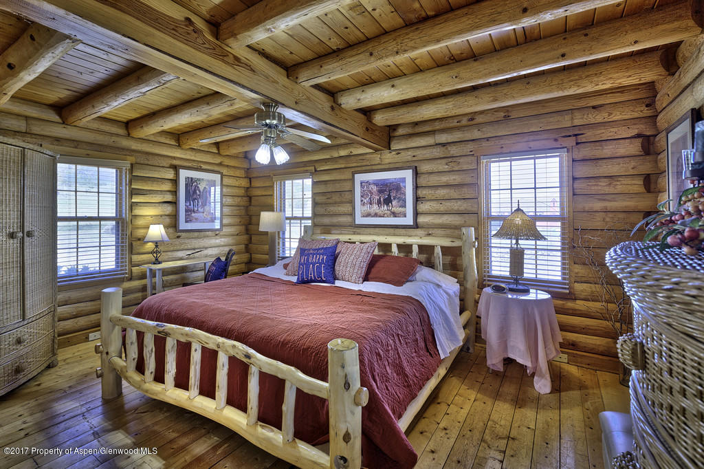 349 Spruce Creek Road Rifle, CO 81650 - Photo 9 of 20 master bedroom with log accents