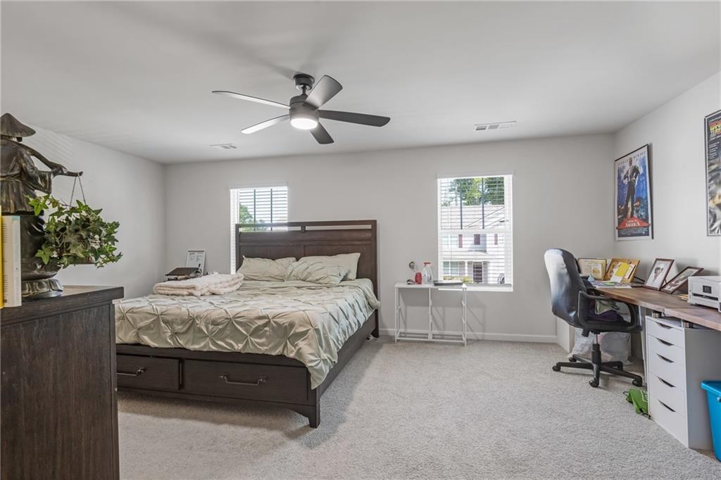 575 Walnut Grv Way Pendergrass, GA 30567 - Photo 23 of 39 a bedroom with a bed table chair and a window