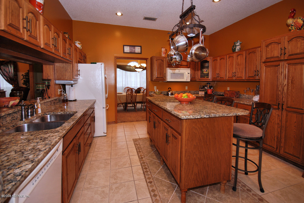 15591 Flounder Road Jacksonville, FL 32226 - Photo 4 of 12 a kitchen with granite countertop sink stove and cabinets