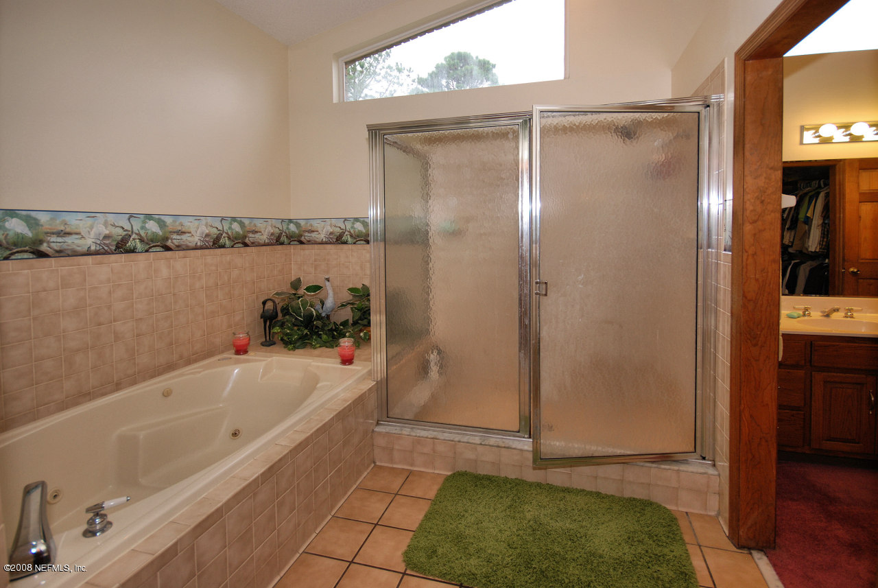 15591 Flounder Road Jacksonville, FL 32226 - Photo 10 of 12 a bathroom with a tub and a shower