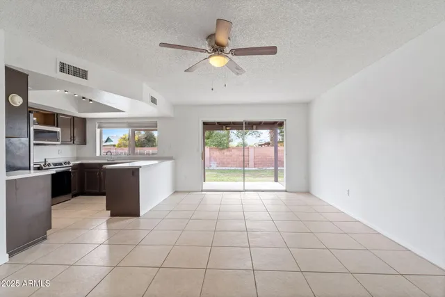 a kitchen with stainless steel appliances a stove a microwave and white cabinets