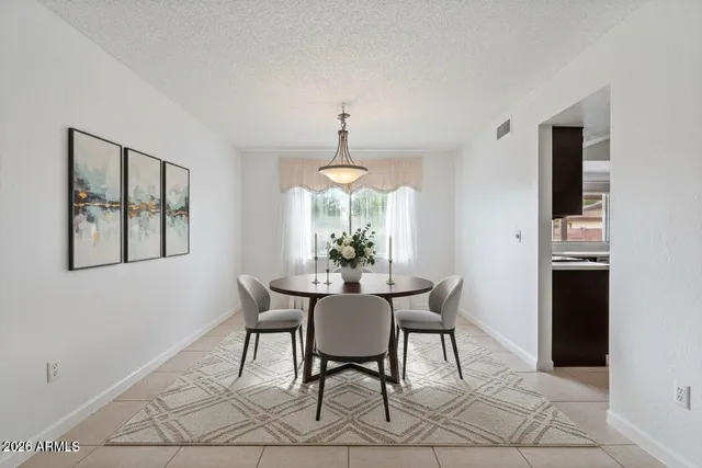 a view of a white house with a yard