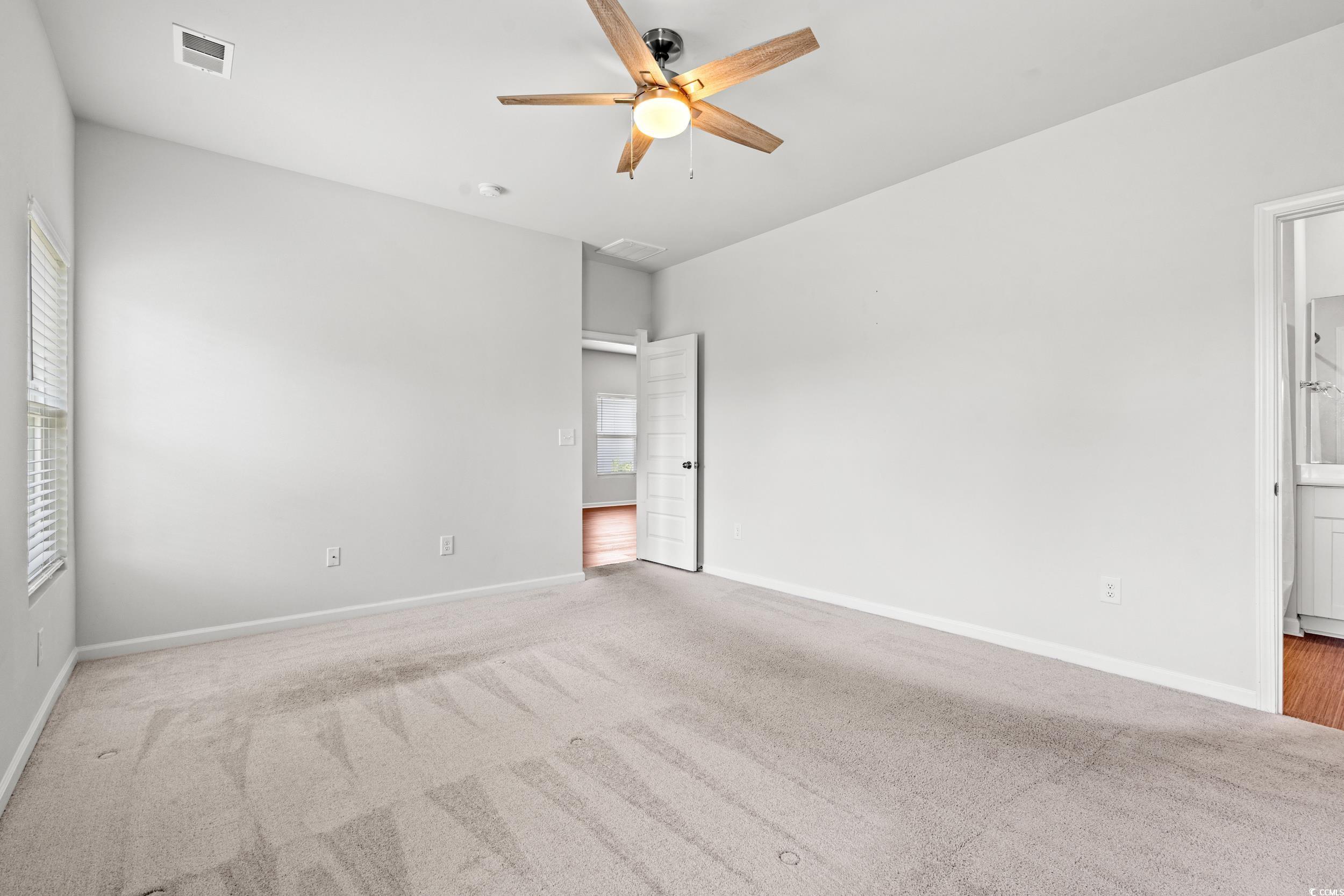 144 Rutland Court Conway, SC 29526 - Photo 11 of 34 Unfurnished bedroom with carpet floors, ensuite bathroom, and ceiling fan