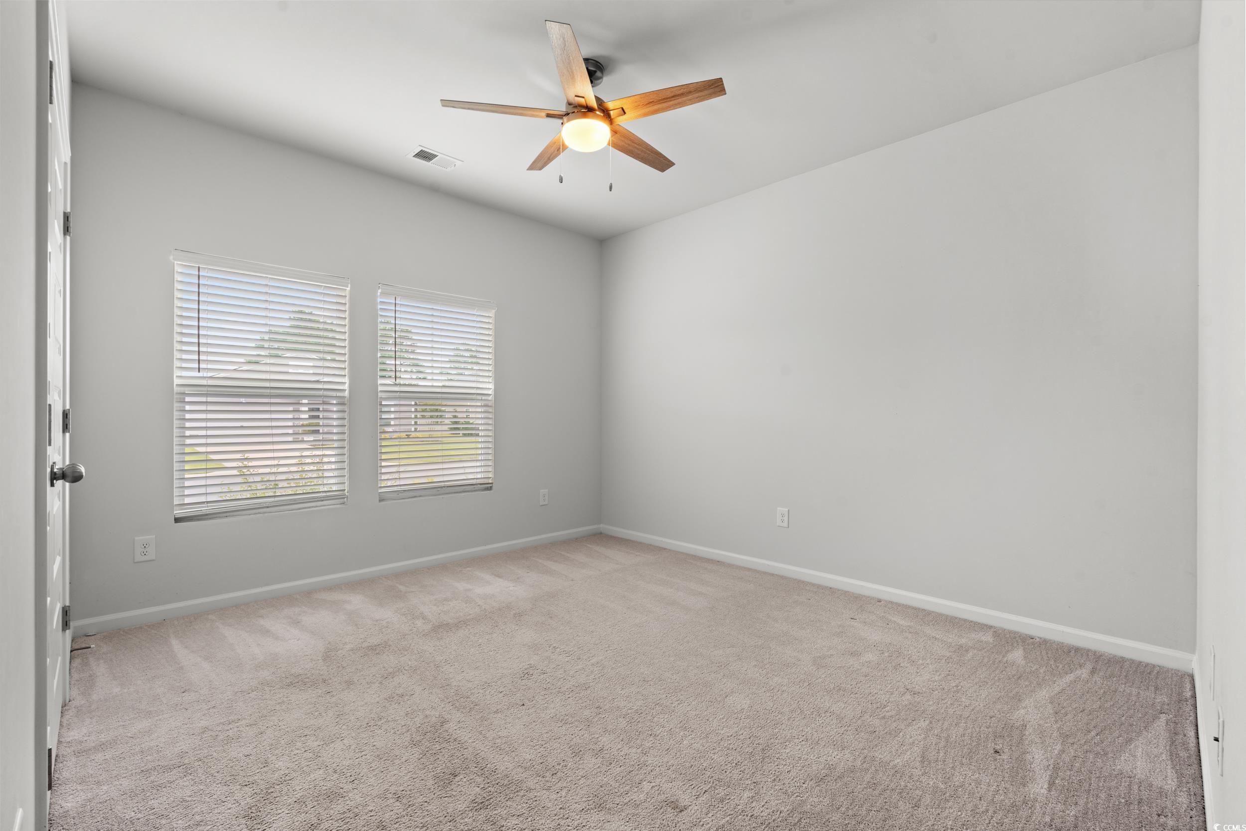 144 Rutland Court Conway, SC 29526 - Photo 16 of 34 Empty room with ceiling fan and light carpet
