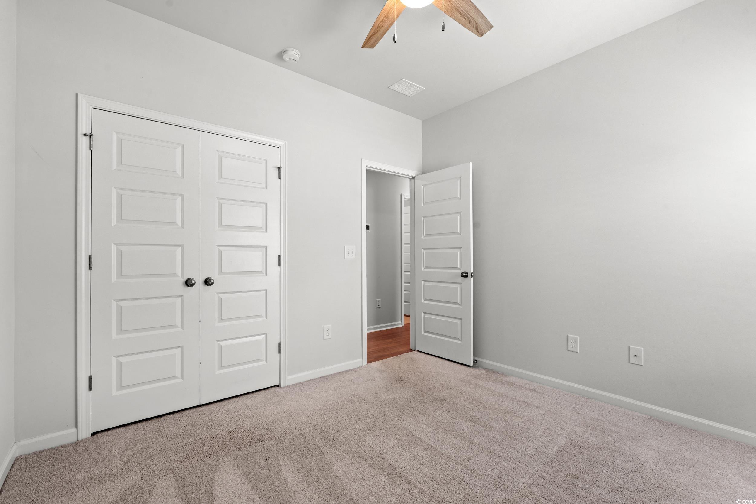 144 Rutland Court Conway, SC 29526 - Photo 18 of 34 Unfurnished bedroom featuring carpet flooring, a closet, and ceiling fan