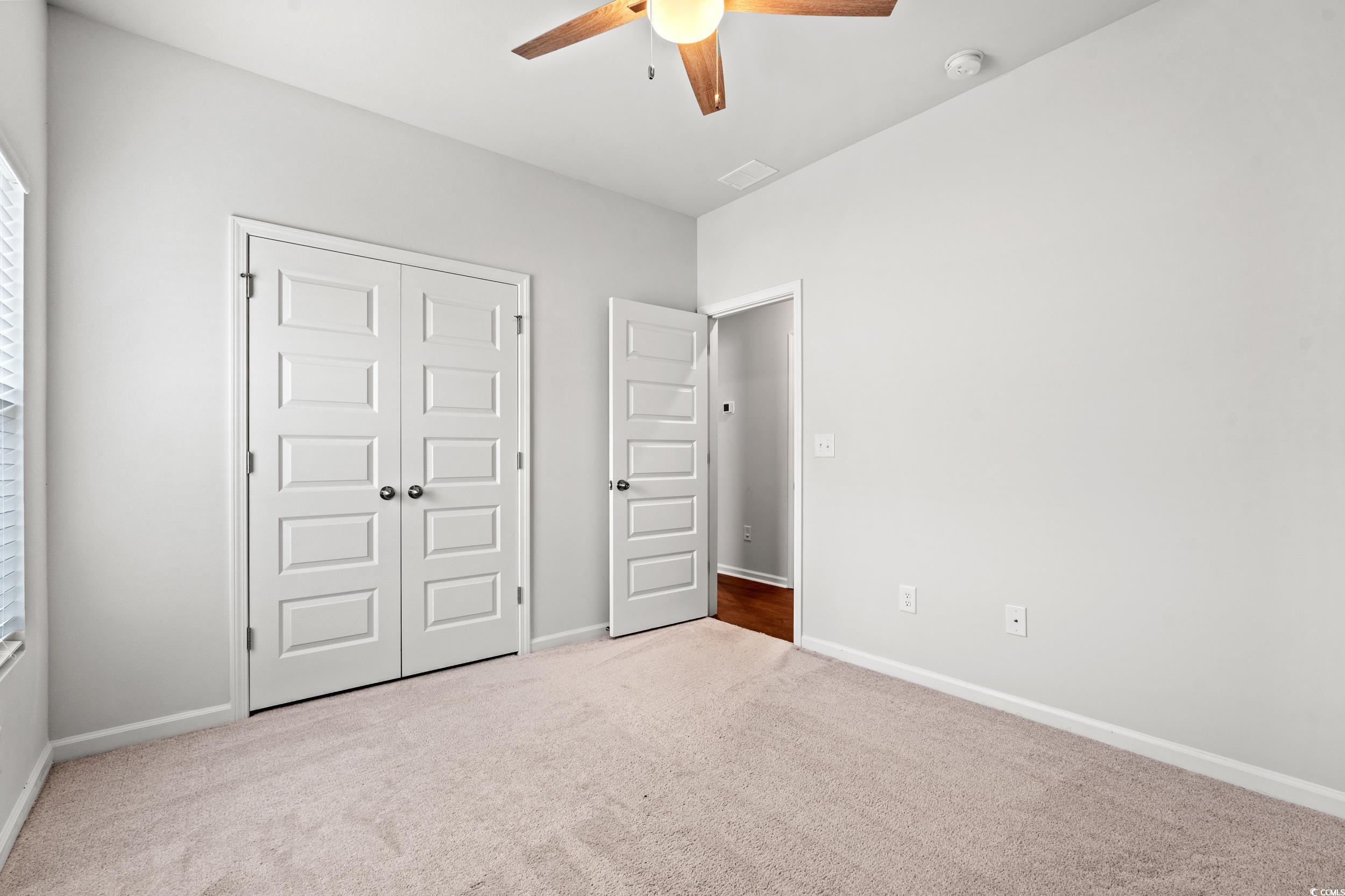 144 Rutland Court Conway, SC 29526 - Photo 20 of 34 Unfurnished bedroom with carpet flooring, a closet, and ceiling fan