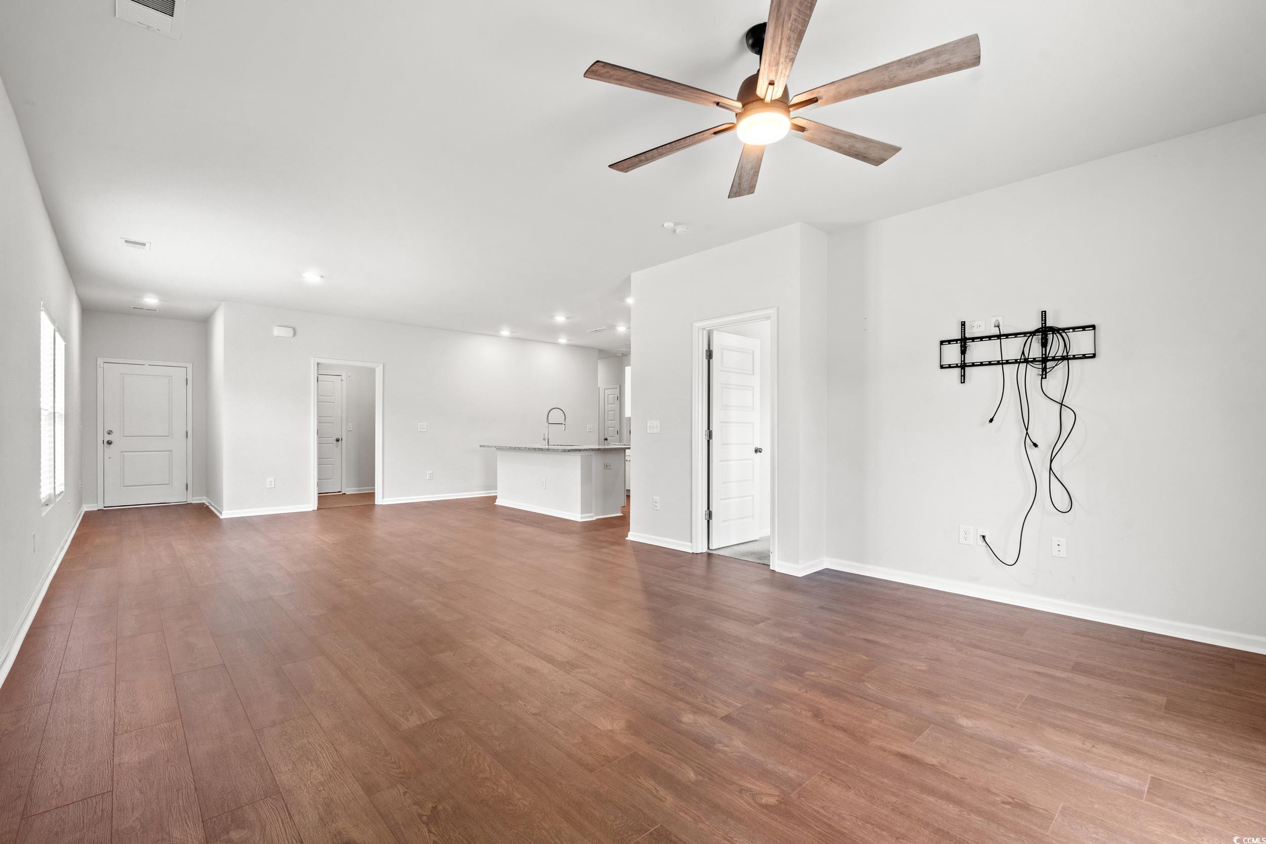 144 Rutland Court Conway, SC 29526 - Photo 8 of 34 Unfurnished living room featuring dark wood-style flooring, a ceiling fan, and recessed lighting
