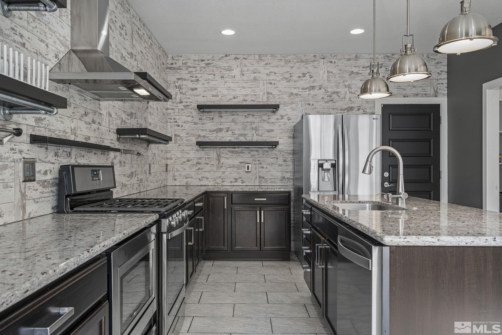 2230 Renzo Way Reno, NV 89521 - Photo 15 of 35 a kitchen with stainless steel appliances granite countertop a sink a stove and a counter space