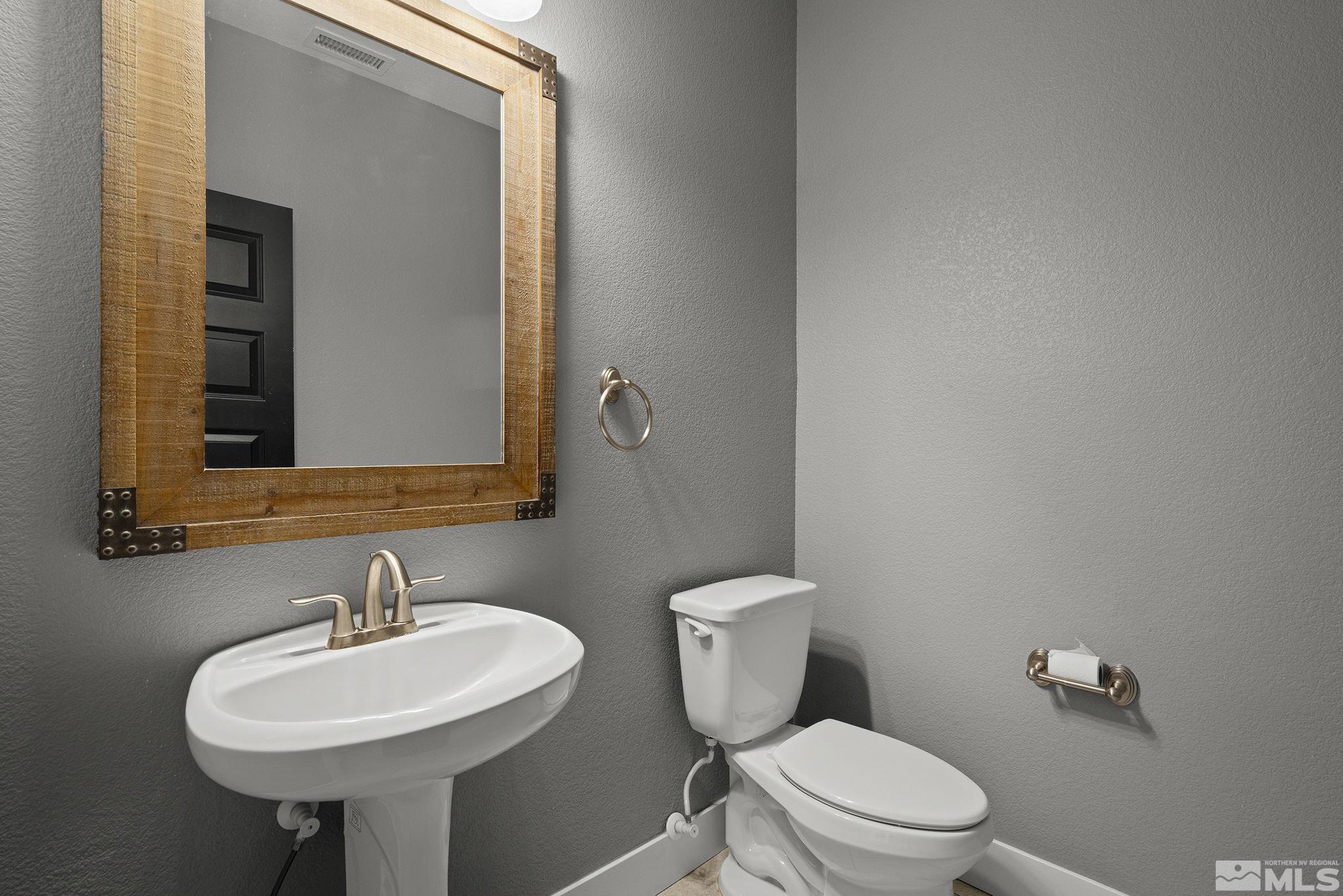 2230 Renzo Way Reno, NV 89521 - Photo 17 of 35 a bathroom with a toilet sink and mirror