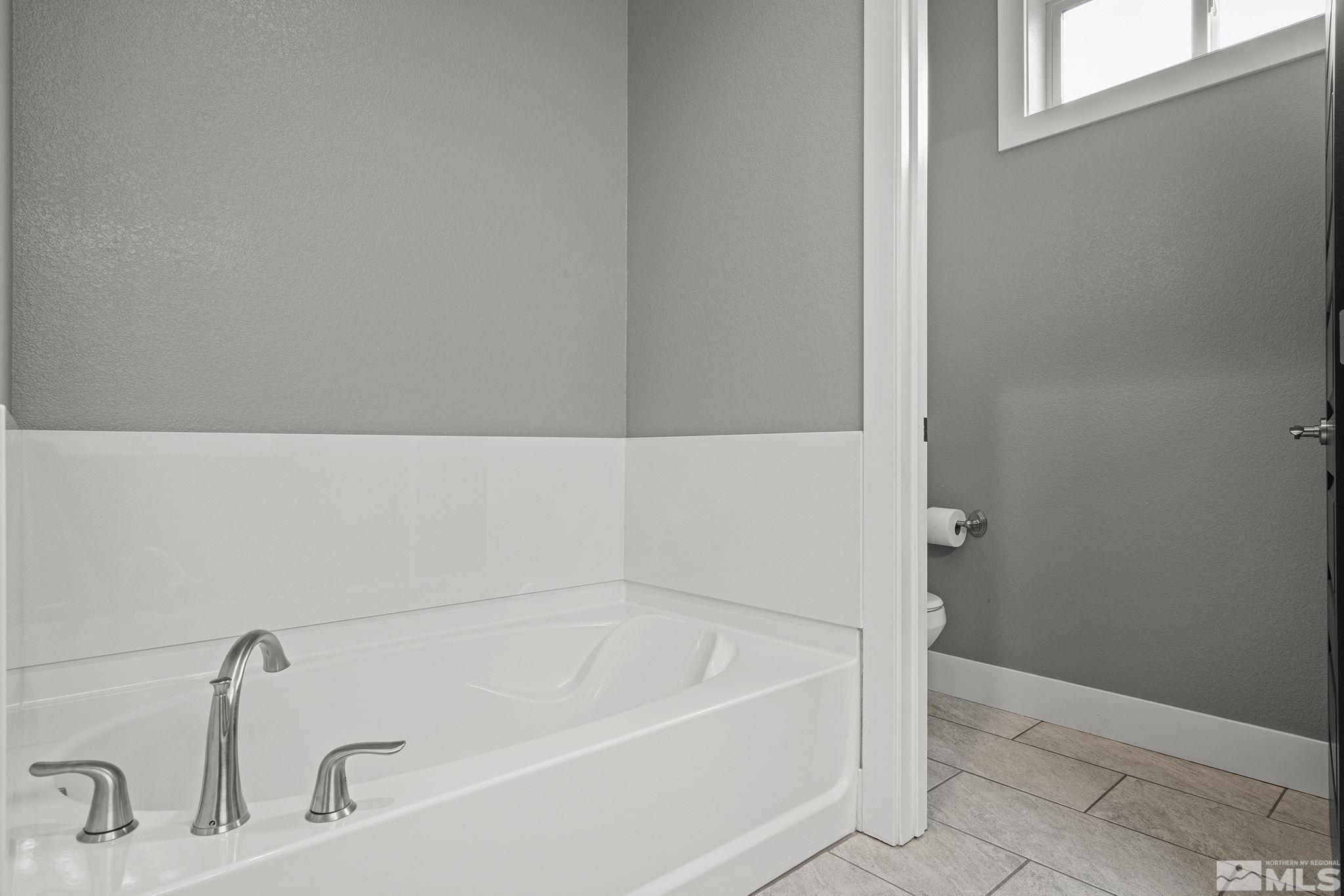 2230 Renzo Way Reno, NV 89521 - Photo 21 of 35 a white bath tub sitting in a bathroom