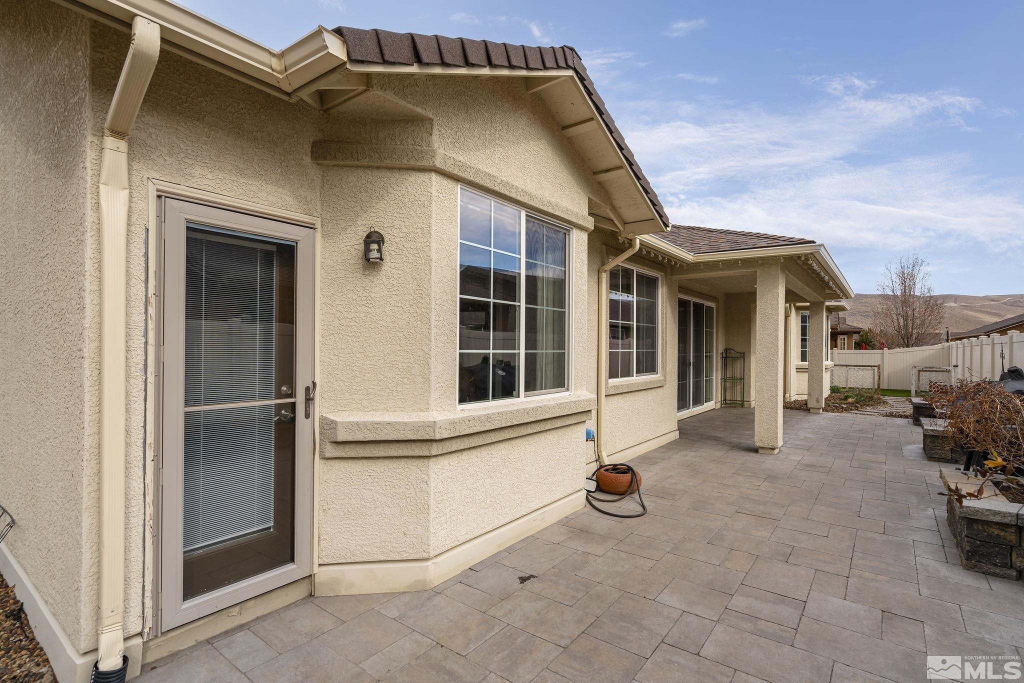 2230 Renzo Way Reno, NV 89521 - Photo 30 of 35 a view of a house with tub and chairs in patio