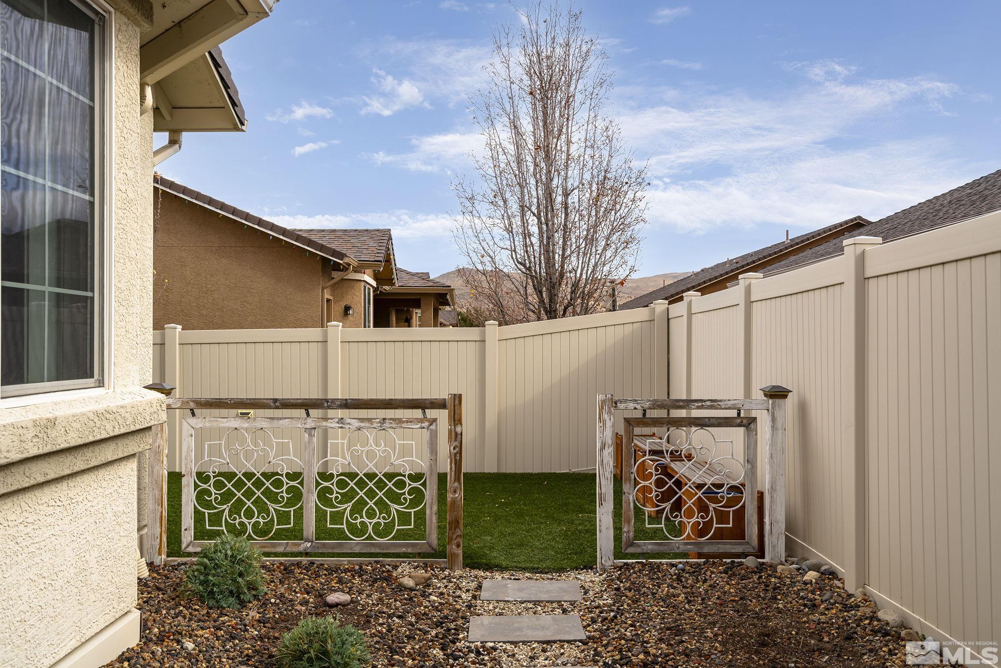 2230 Renzo Way Reno, NV 89521 - Photo 31 of 35 a view of a house with a large window plants and wooden fence