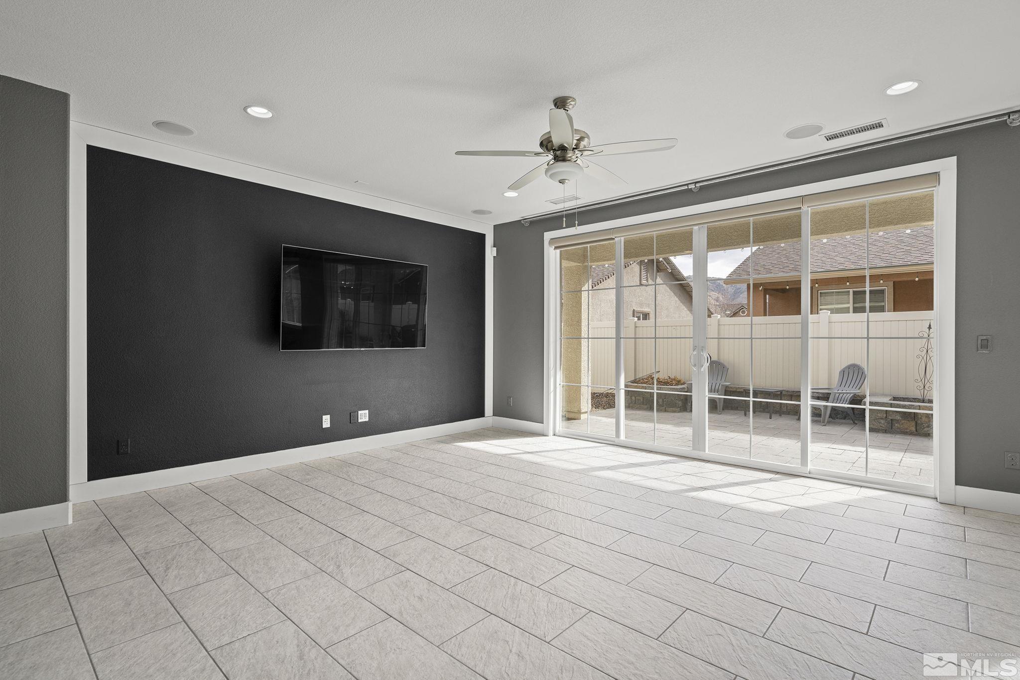 2230 Renzo Way Reno, NV 89521 - Photo 7 of 35 a view of an empty room with a window and a flat screen tv