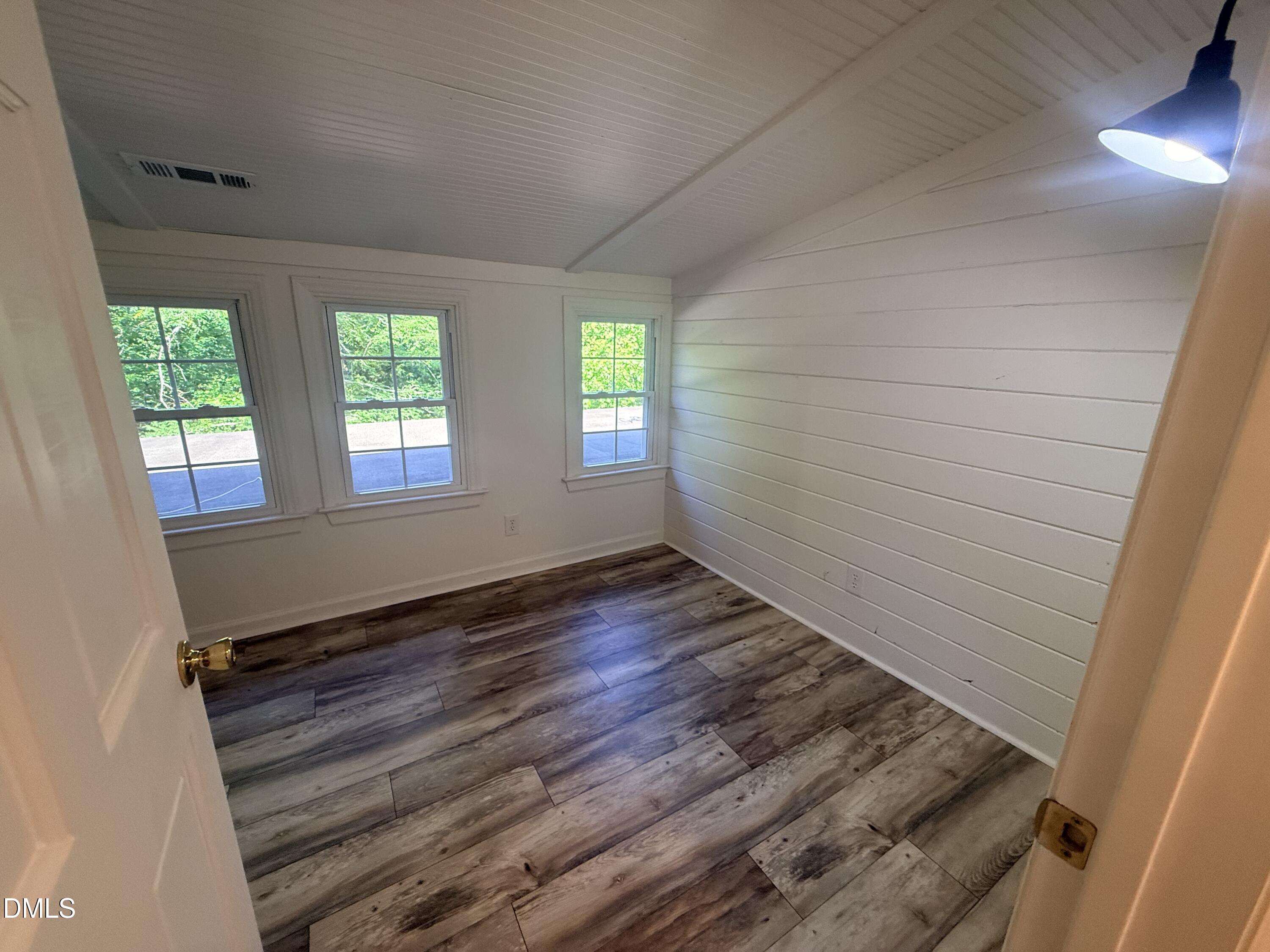 327 Shady Oak Road Roxboro, NC 27574 - Photo 43 of 62 an empty room with wooden floor and windows