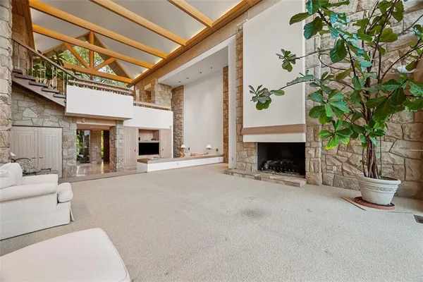 a view of a patio with couches and a fireplace