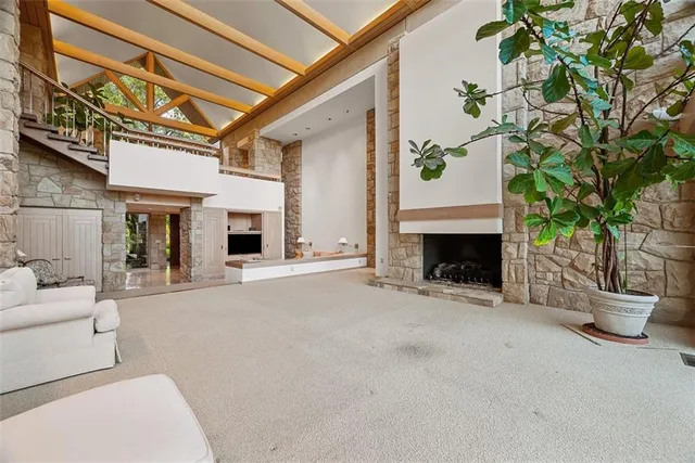 a view of a patio with couches and a fireplace