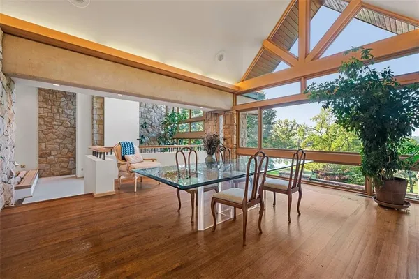 a dining room with furniture window and wooden floor