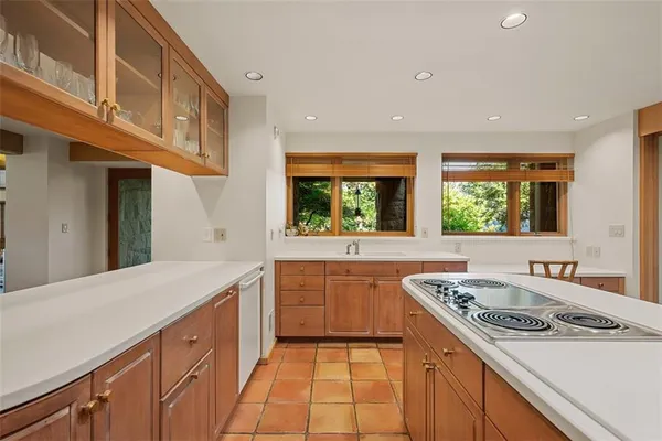 a kitchen with a stove a sink and a refrigerator