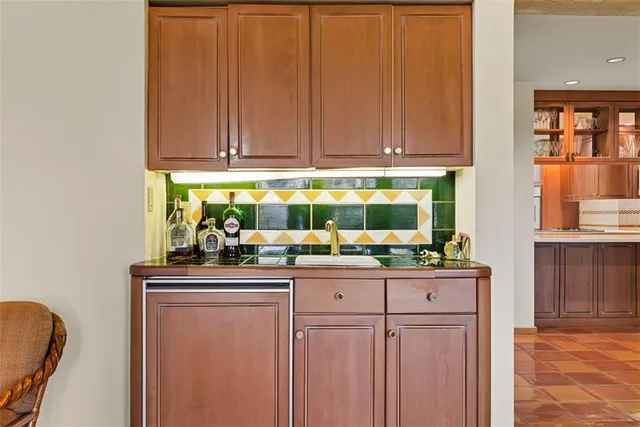 a kitchen with granite countertop a sink and cabinets