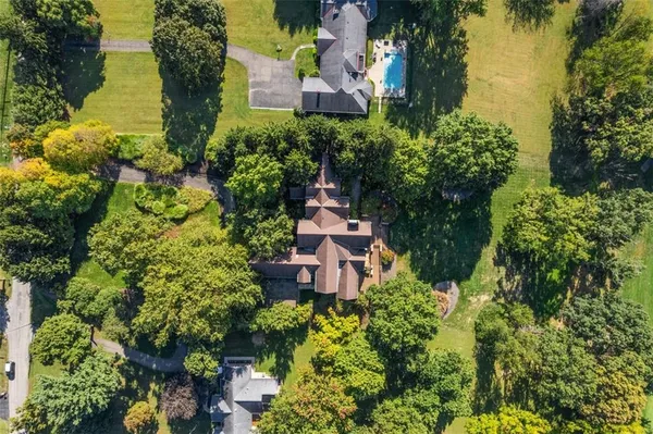 an aerial view of a house with a garden and lake view