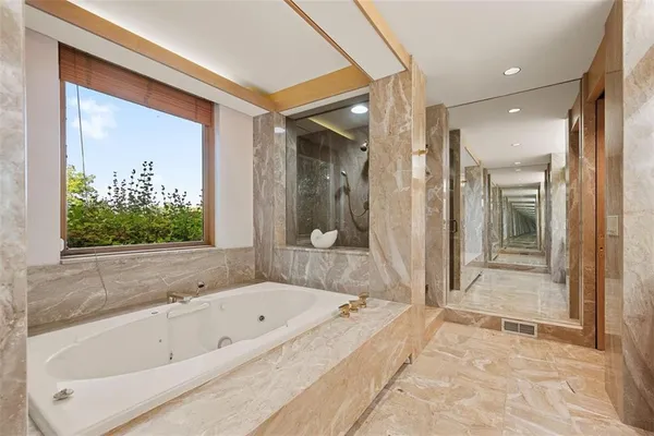a bathroom with a shower and a glass door