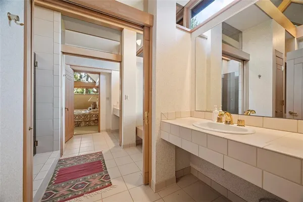 a en suite bathroom with a sink a mirror and a shower