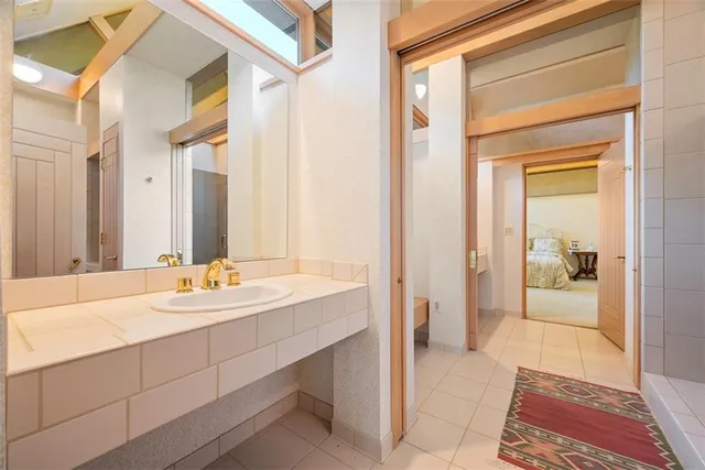 a bedroom with two beds and a large window with outer view