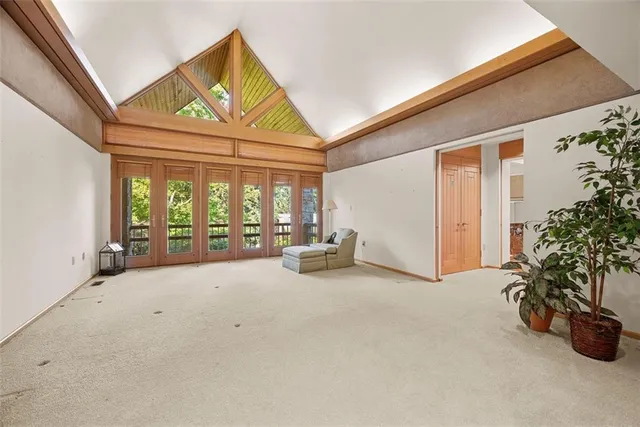 a view of a livingroom with furniture and floor to ceiling window