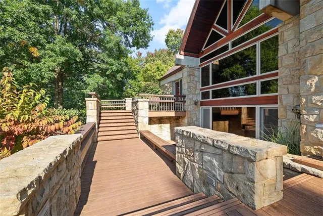 a front view of a house with yard and green space