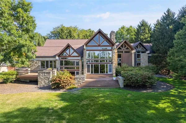 an aerial view of residential house with outdoor space and lake view
