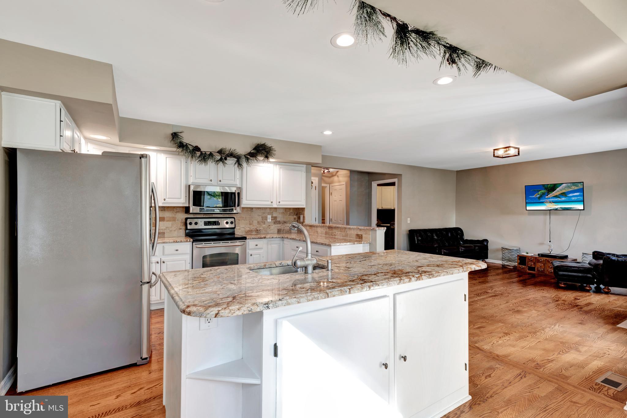 29 Southampton Parish Road Landenberg, PA 19350 - Photo 14 of 56 a kitchen with stainless steel appliances kitchen island granite countertop a refrigerator and a stove top oven