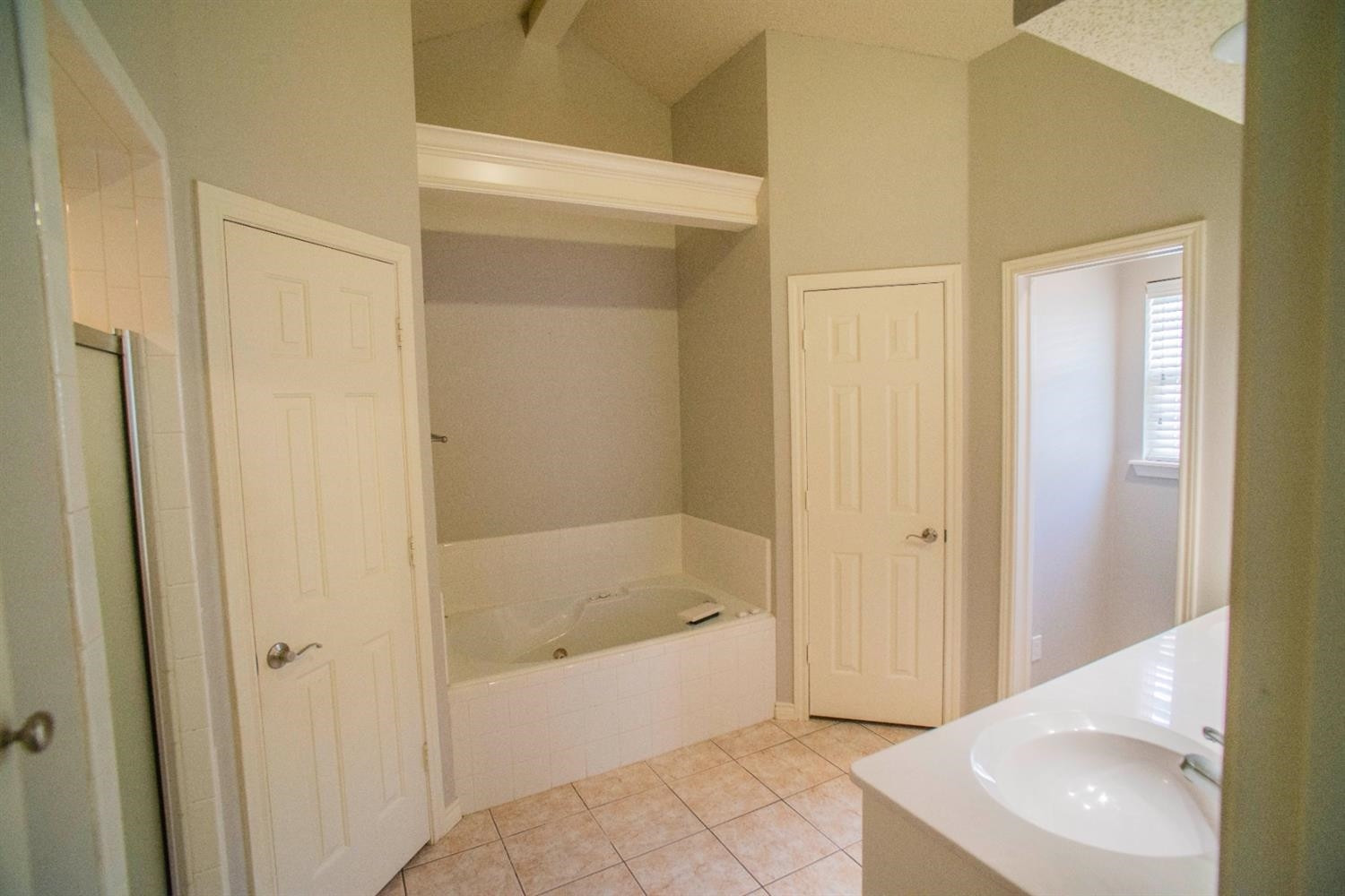 5502 103rd Street Lubbock, TX 79424 - Photo 12 of 15 a spacious bathroom with a bathtub and a sink
