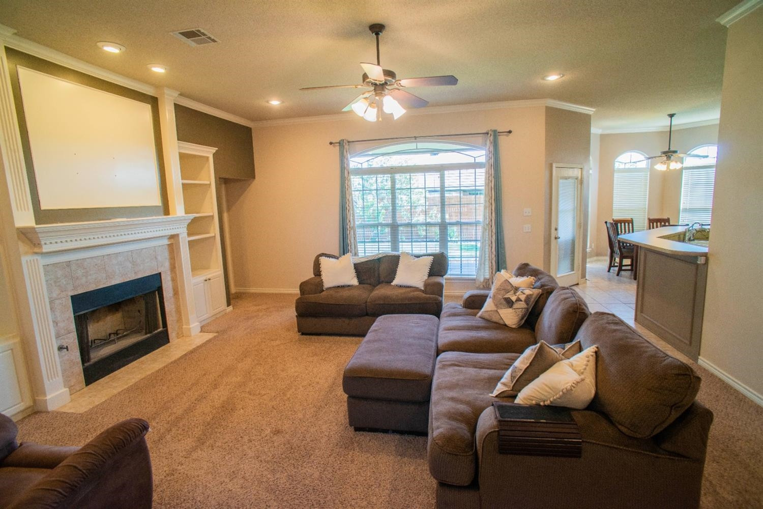5502 103rd Street Lubbock, TX 79424 - Photo 2 of 15 a living room with furniture and a fireplace