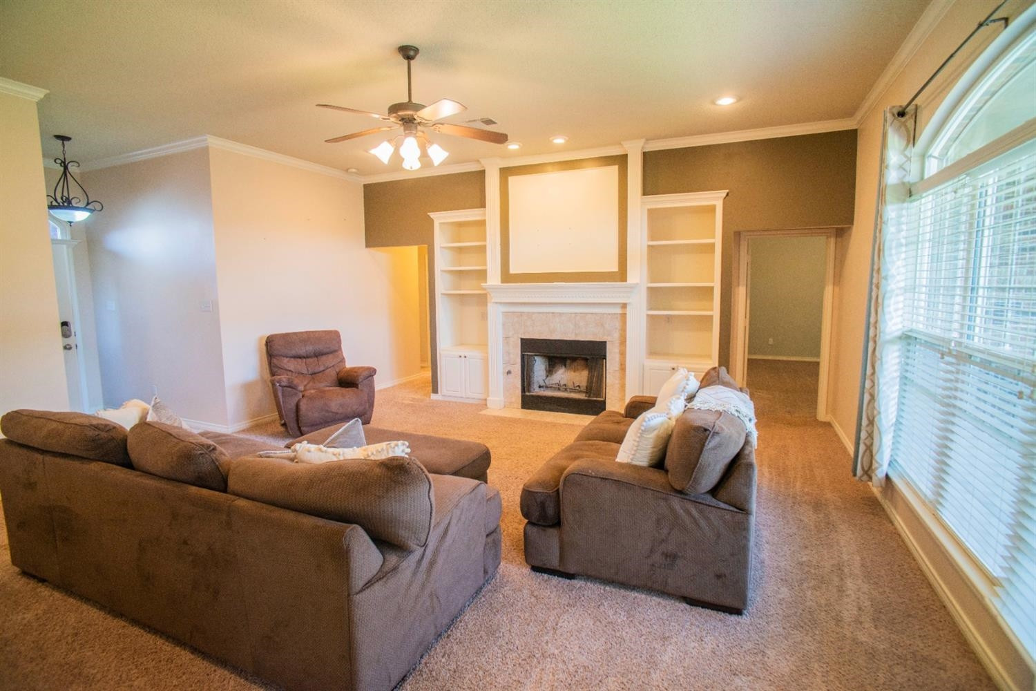 5502 103rd Street Lubbock, TX 79424 - Photo 3 of 15 a living room with furniture and a fireplace