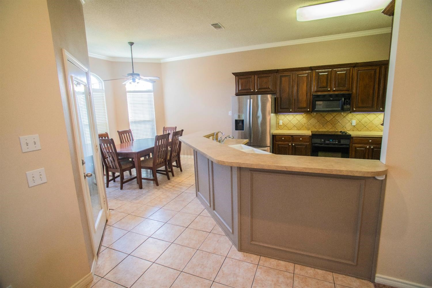5502 103rd Street Lubbock, TX 79424 - Photo 4 of 15 a kitchen with a sink and chairs