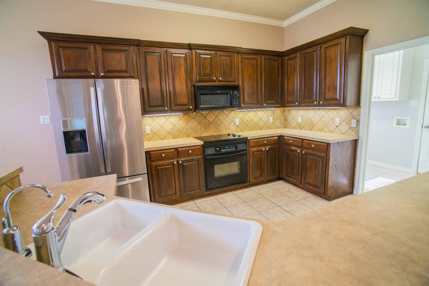 5502 103rd Street Lubbock, TX 79424 - Photo 5 of 15 a kitchen with stainless steel appliances granite countertop a sink stove and refrigerator