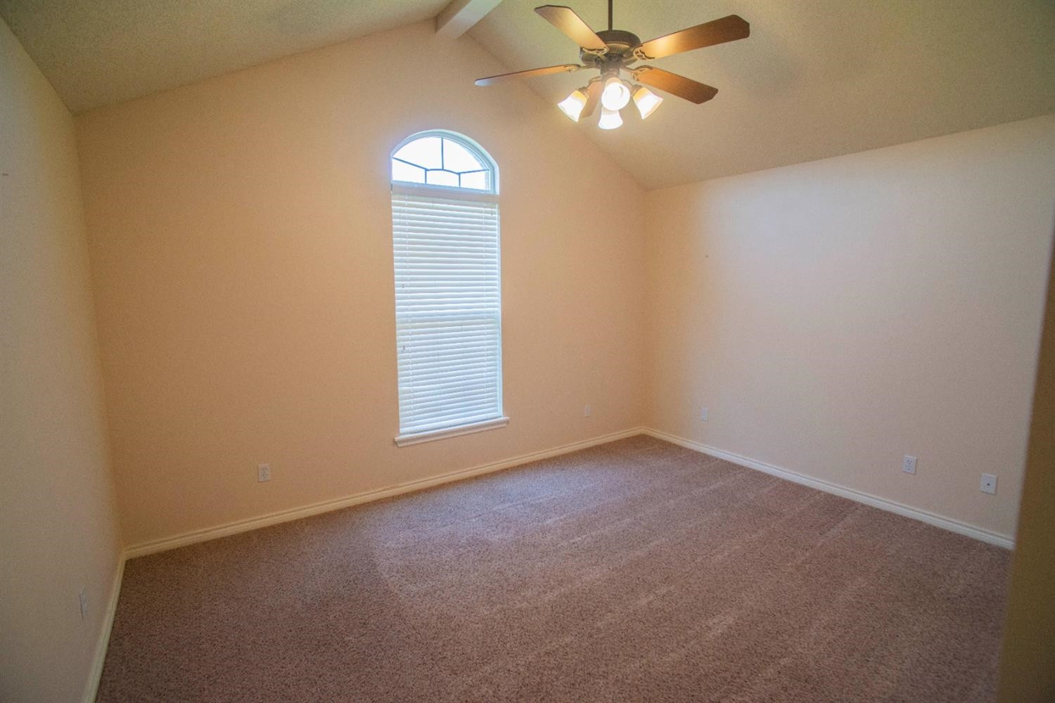 5502 103rd Street Lubbock, TX 79424 - Photo 8 of 15 an empty room with a window and ceiling fan