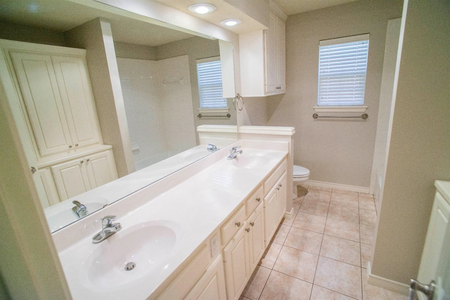 5502 103rd Street Lubbock, TX 79424 - Photo 9 of 15 a spacious bathroom with a tub sink and mirror