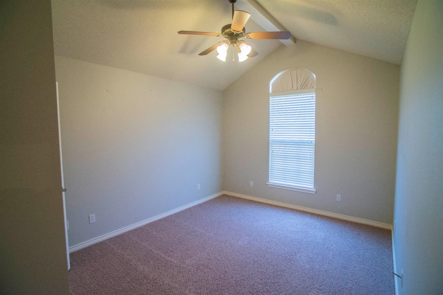 5502 103rd Street Lubbock, TX 79424 - Photo 10 of 15 an empty room with windows and fan